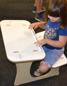 SKOG KIDS activity table with a large  preschooler.